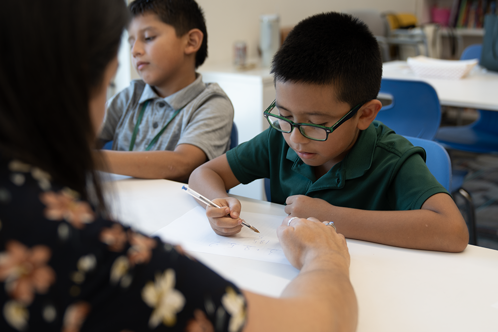 partnership with UF, young boy working on math